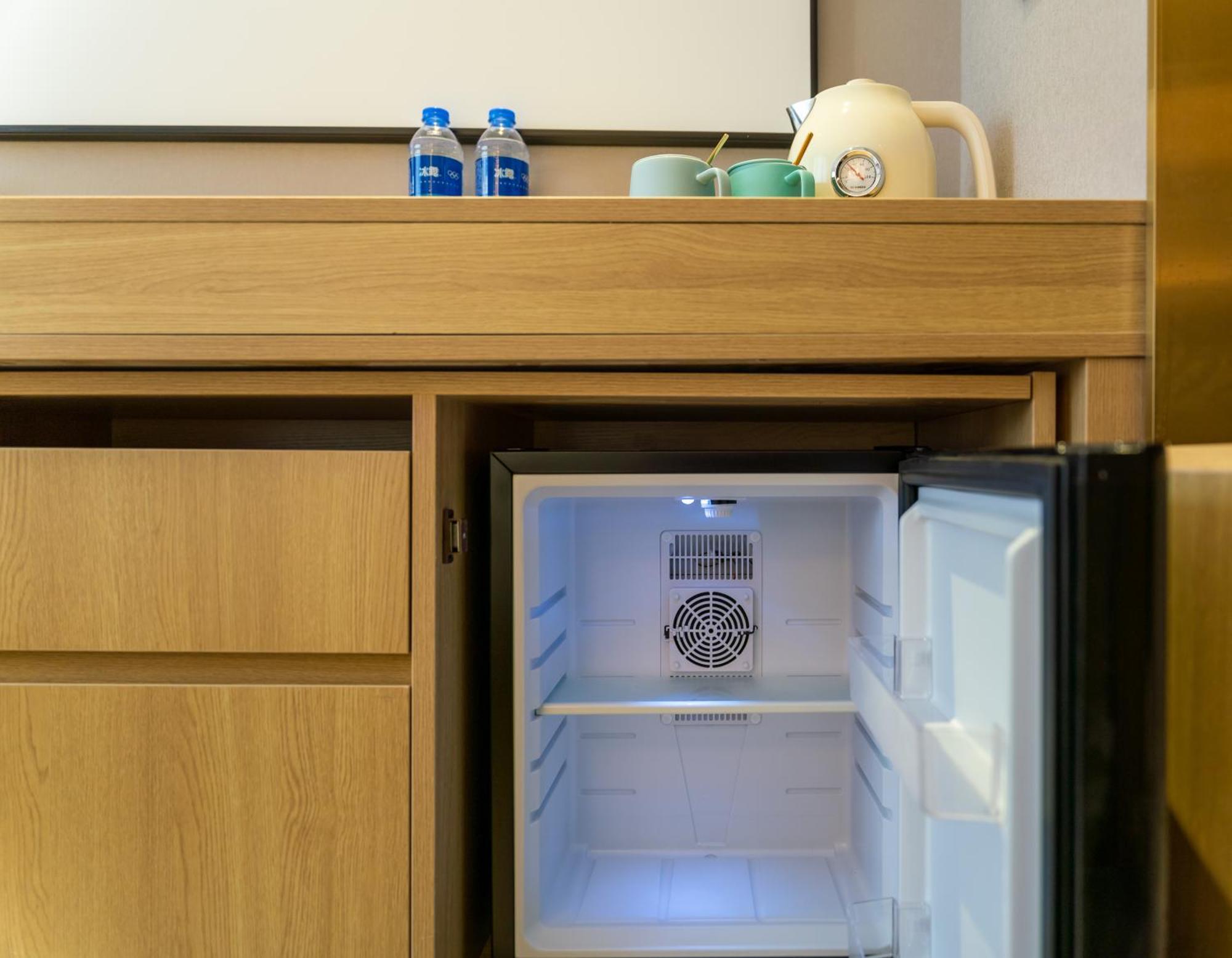 East Sacred Hotel: Tiananmen Square Proximity with Tourism Services Beijing Exterior photo A mini-refrigerator in a hotel room